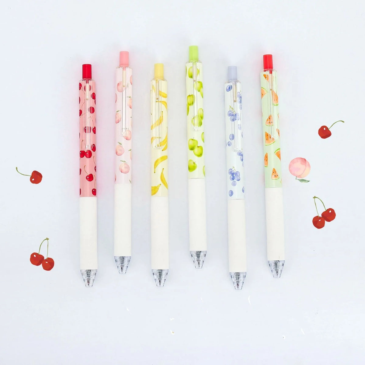 Three fruit scented 0.5mm black ink click pens with plastic barrels and replaceable refills