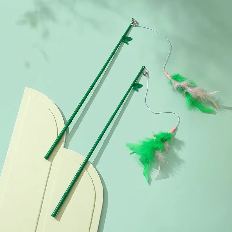 Green interactive cat feather wand toy with bell and feather attachments for indoor play