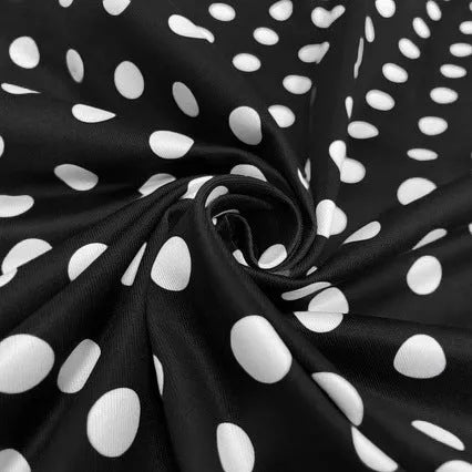 Multicolour polka dot women's dress with square collar, short sleeves, and pleated mid-length skirt.