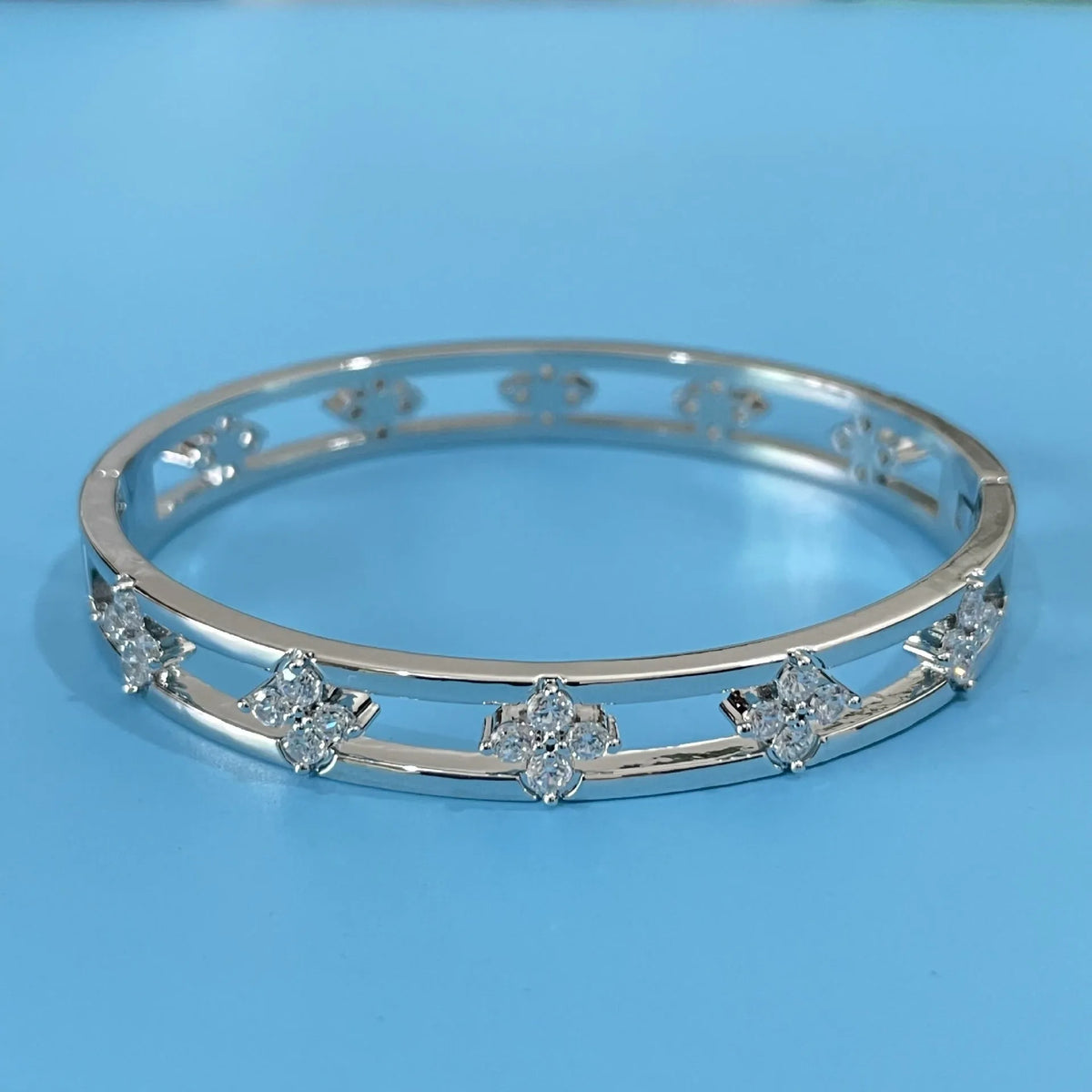 Gold or silver buckle hollow women's bracelet with four-leaf clover charm and zircon detail