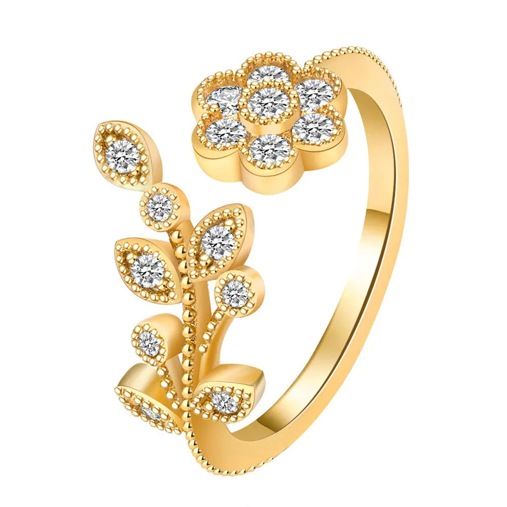Copper open ring with flower and leaf design in gold colour.