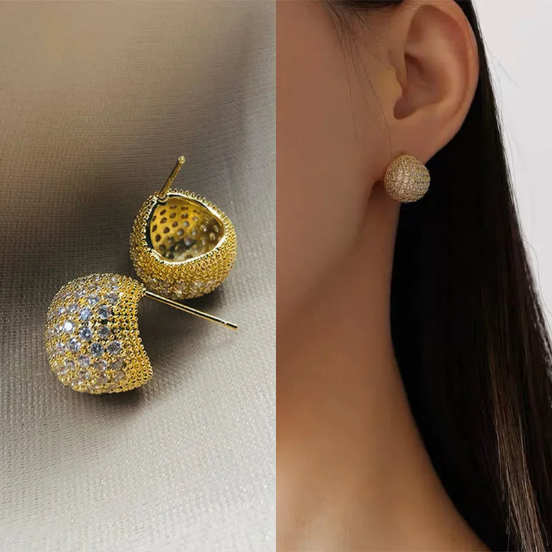 Gold and white women's drop earrings with geometric sphere and diamond-cut golden bean design