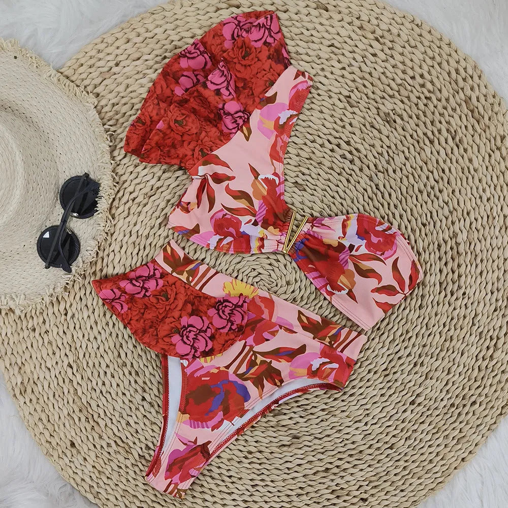 Women's pink floral print one-shoulder swimsuit with high-waist briefs and ruffled detailing