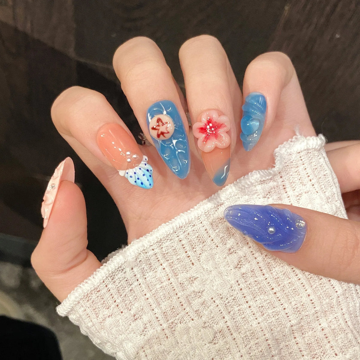 Three-dimensional carved jellyfish design on plastic wearable armour in almond nail colour.