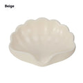 Shell-shaped white plastic soap dish with drainage for bathroom use