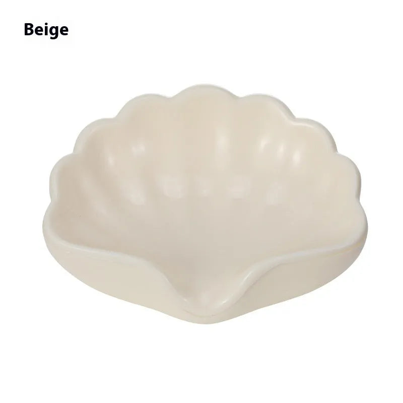 Shell-shaped white plastic soap dish with drainage for bathroom use