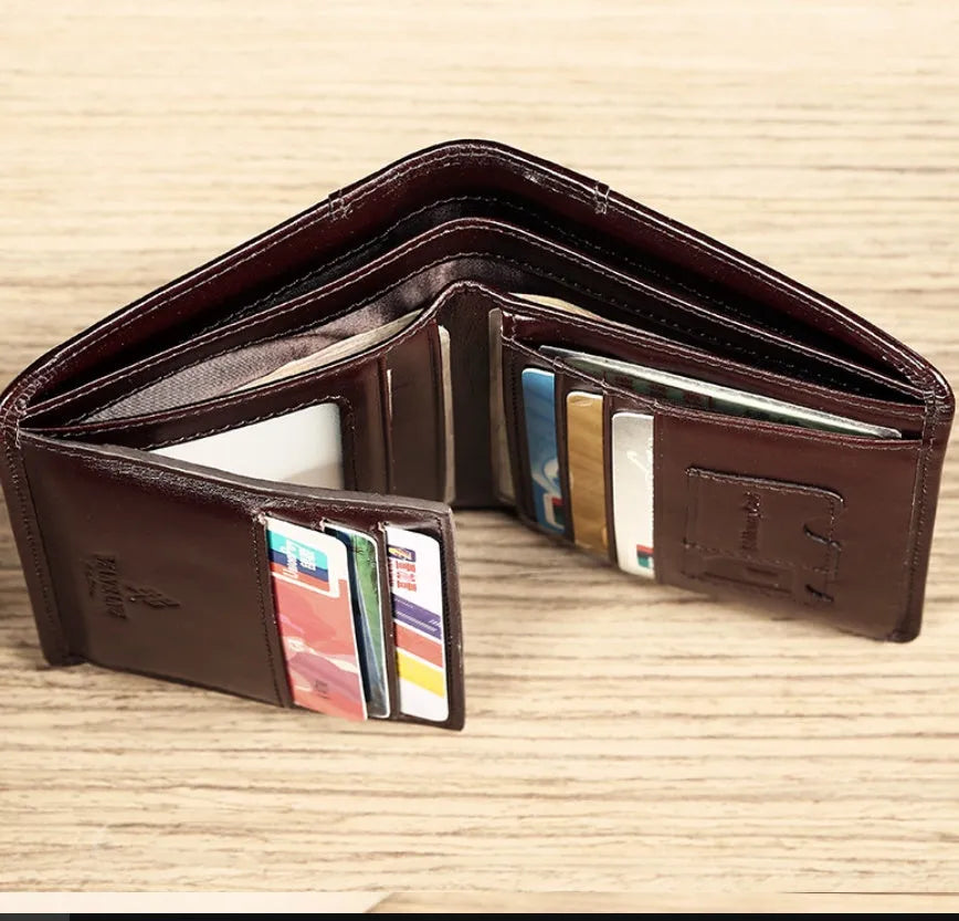 Men's brown leather wallet open to show card slots, ID window, coin pocket, and banknote fold.