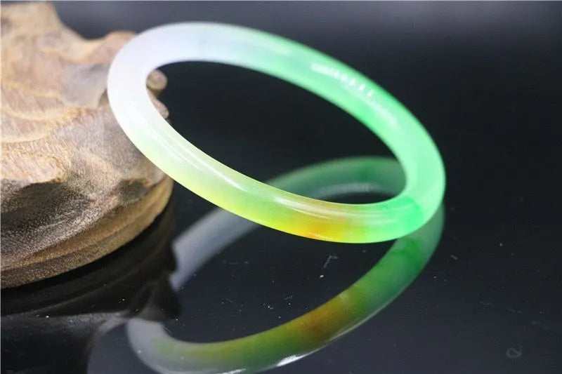 Women's jade bracelet with floating flower design in multiple colour options showing adjustable sizing