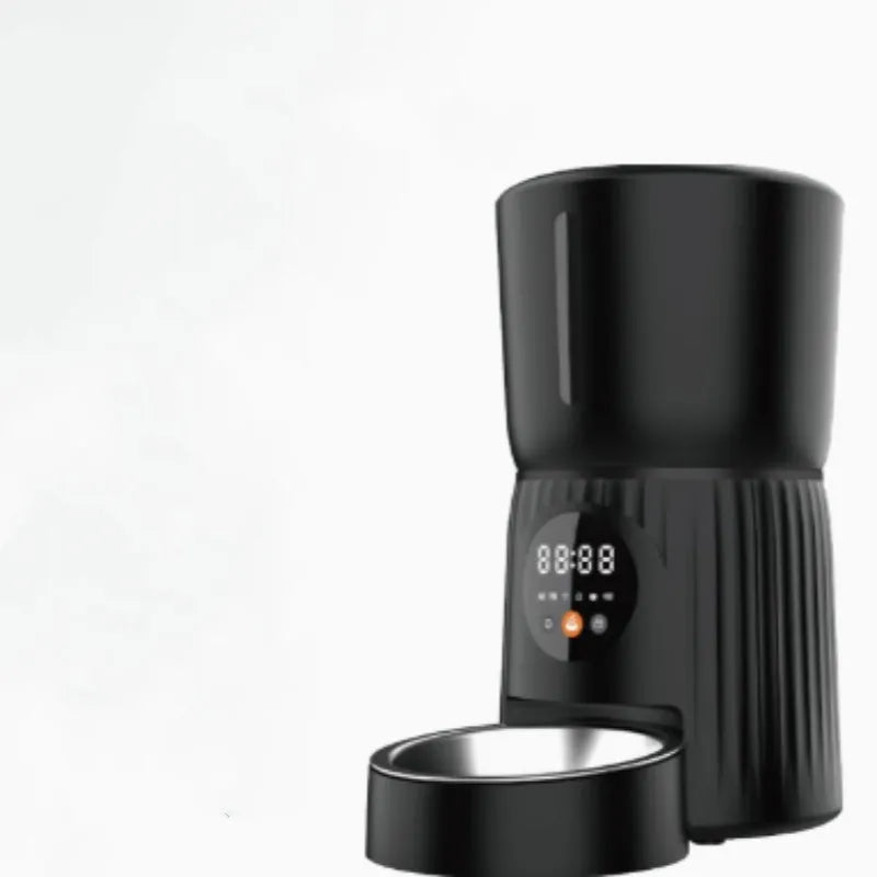 Black automatic pet feeder with digital display and food container showing portion control mechanism
