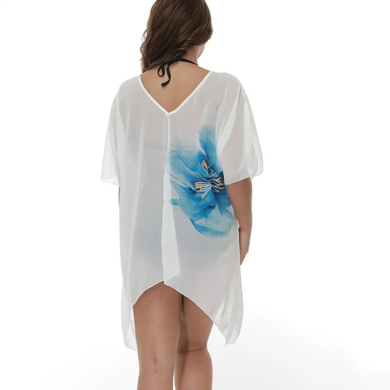 White plus size loose beach cover-up blouse for women on a beach.