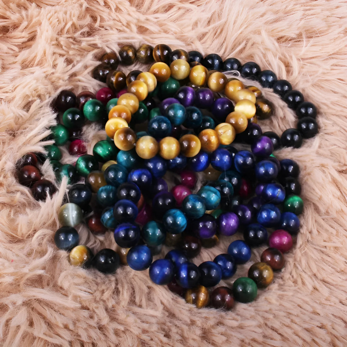 Natural Tigereye crystal bracelet with round beads, showing colour options including dark blue, green, and red tiger eye.