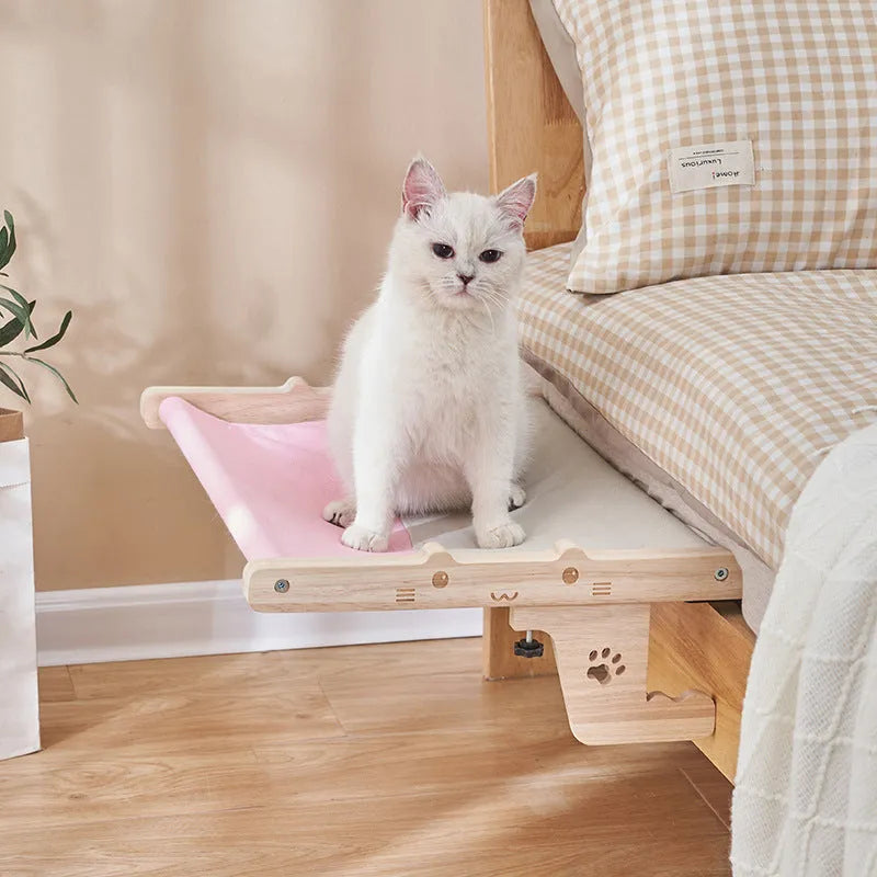 Wooden cat hanging bed hammock suspended by rope, shown installed on a balcony.