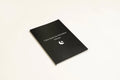 Black hardcover dream journal notebook with blank interior pages.