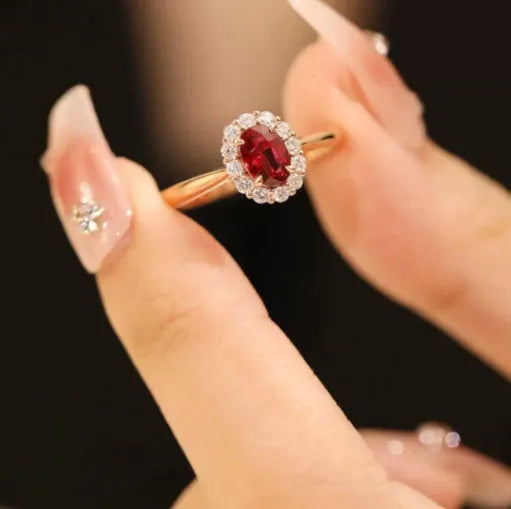 Women's silver-plated floral ring with a gold pigeon red blood gemstone centrepiece.