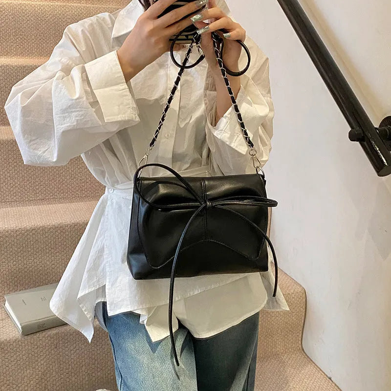 Women's black PU crossbody underarm bag with horizontal square shape and visible sewing line detailing