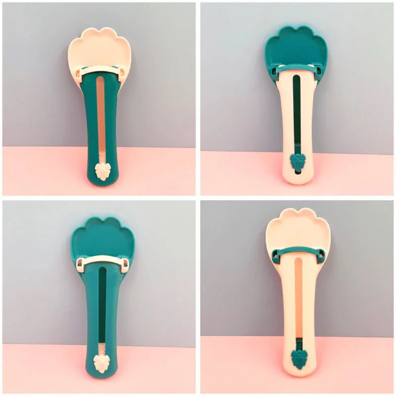 Green and pink pet food scoop squeezer feeder for dispensing snacks and liquids for cats and dogs.