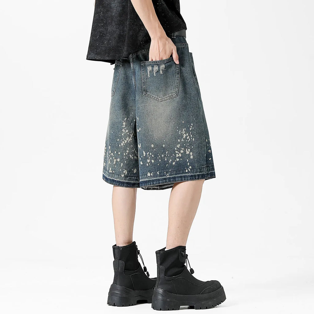 Men's retro washed blue denim shorts with splash ink detailing and ripped accents