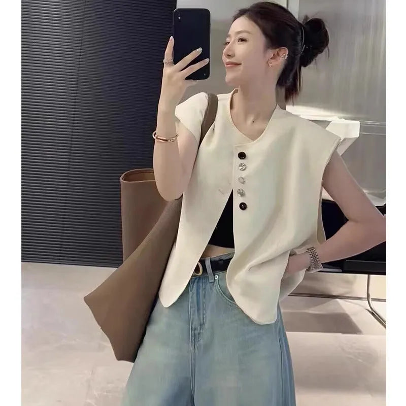 Women's loose-fit short vest in milky white with a chest pocket, shown on a hanger.