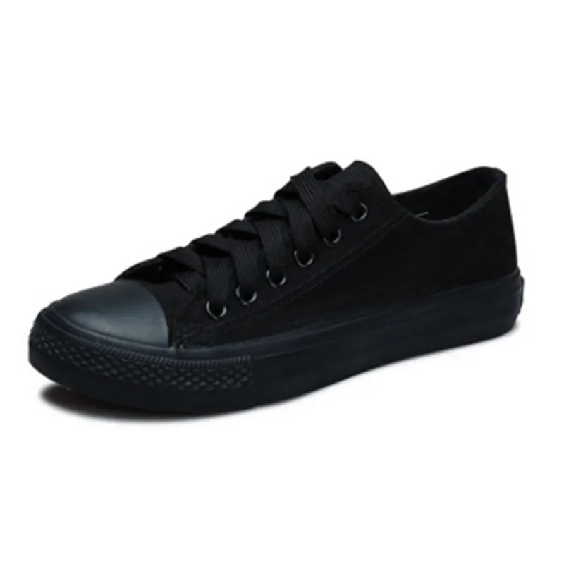 Women's solid-colour canvas lace-up trainers on a white background, showing the casual design and lace detail.