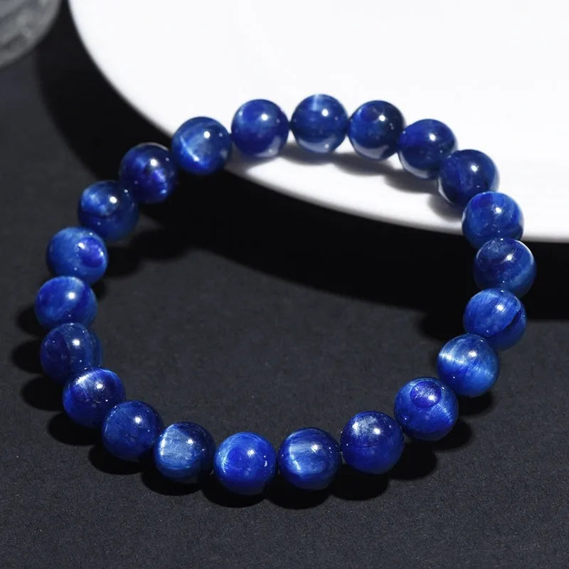 Natural blue crystal bead bracelet with geometric design and polished finish on a wrist.