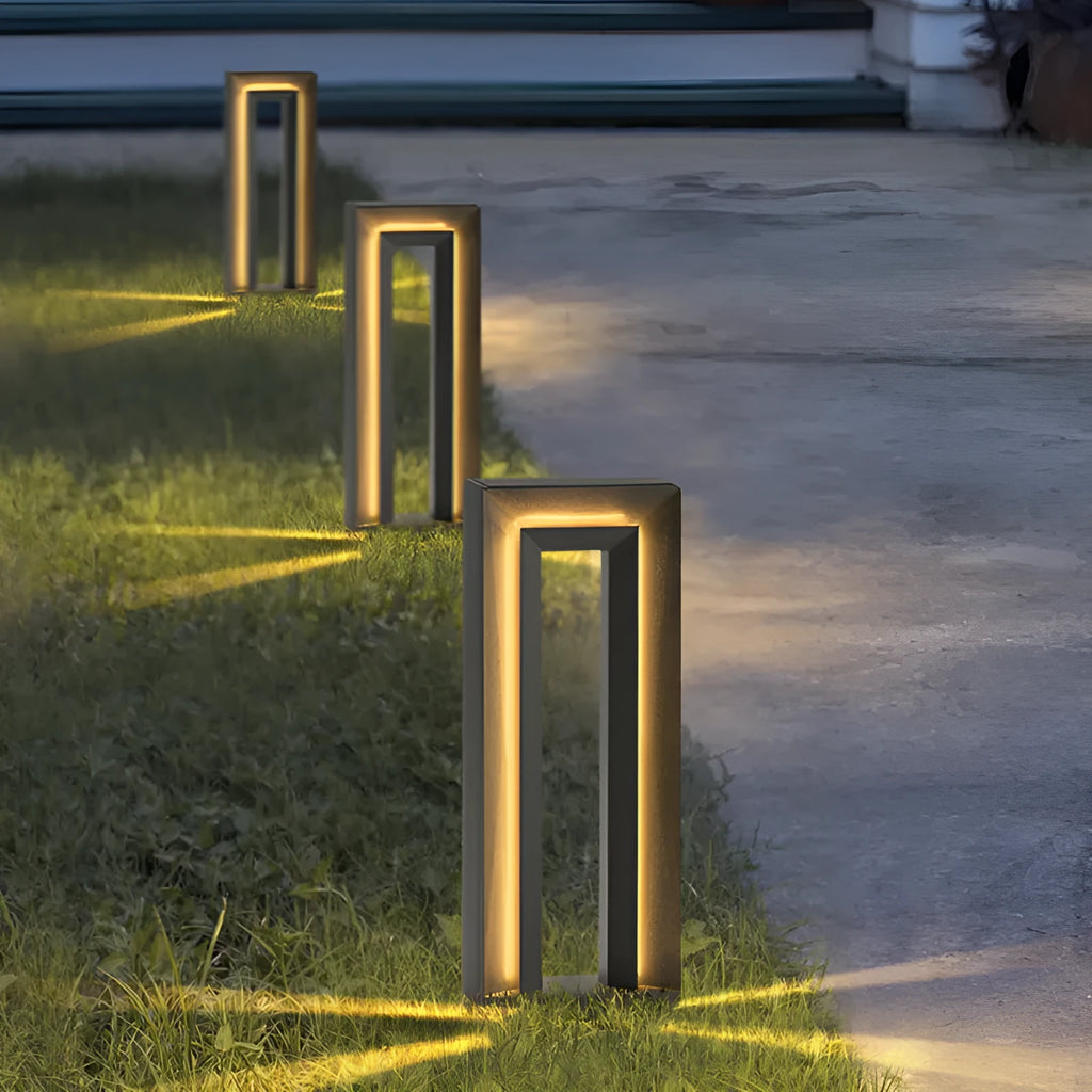 A modern square-shaped stainless steel and acrylic outdoor garden lamp with a geometric design.