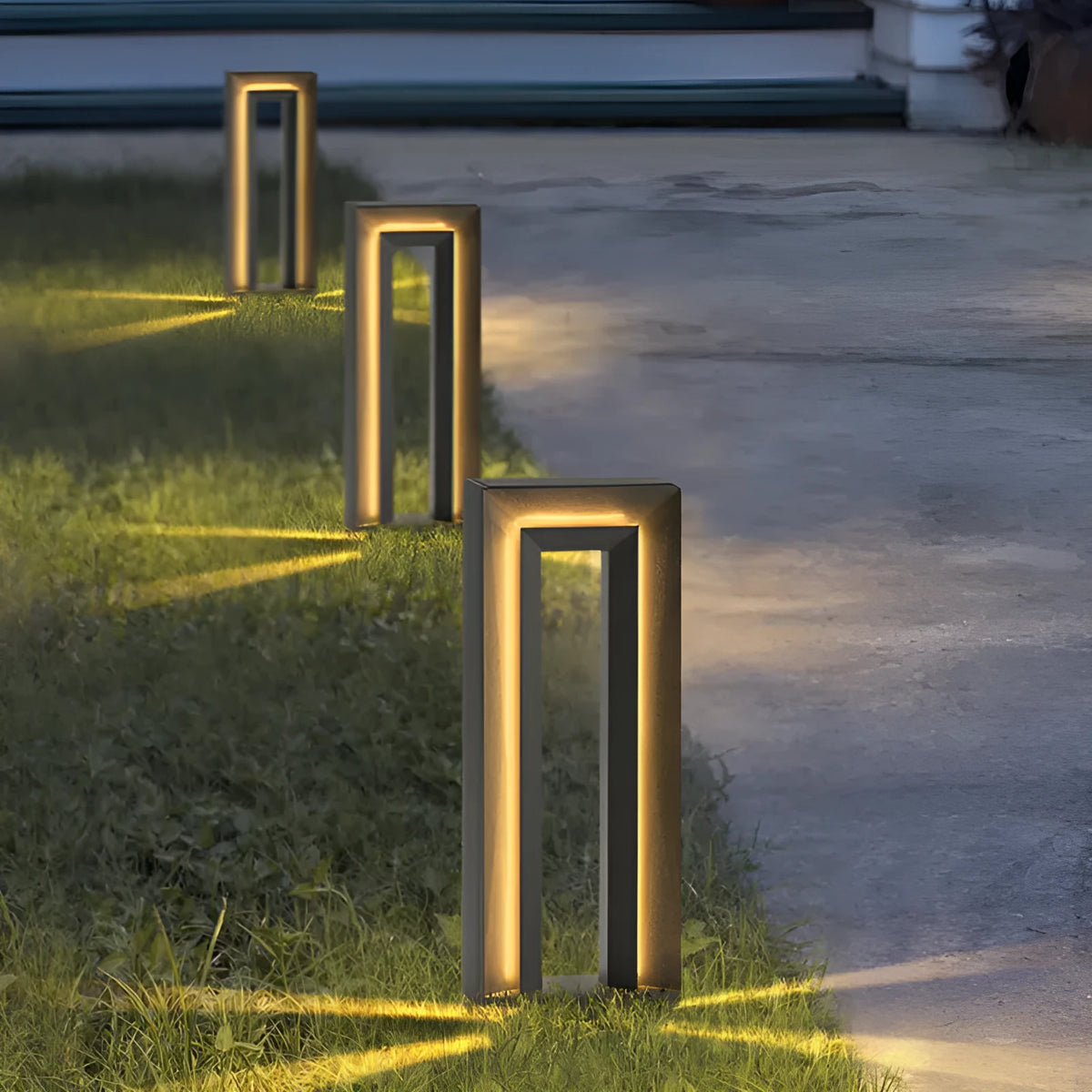 A modern square-shaped stainless steel and acrylic outdoor garden lamp with a geometric design.