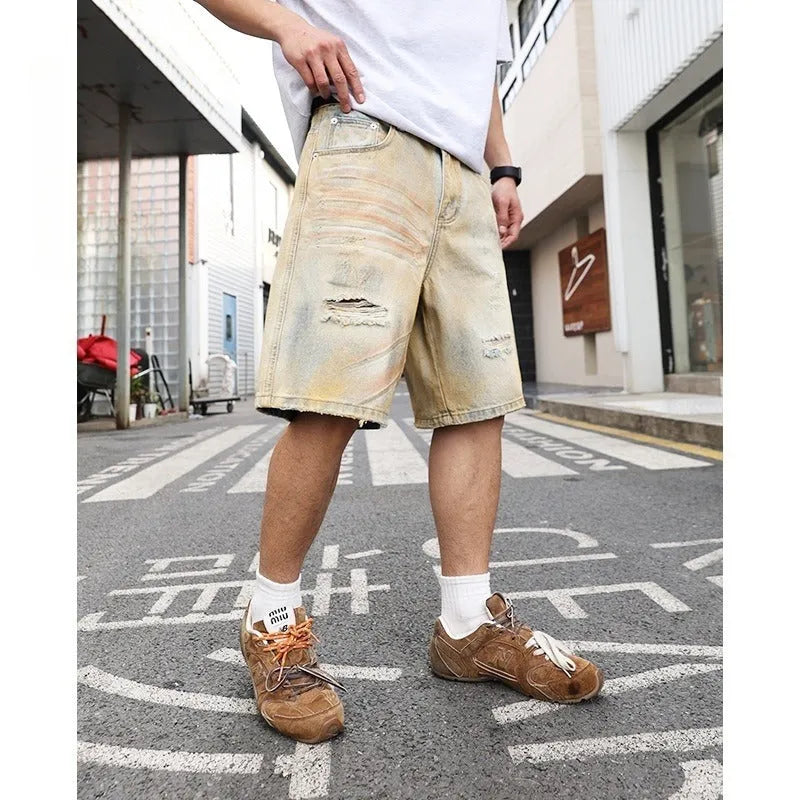 Light blue distressed denim shorts for men with ripped details and straight-leg fit.