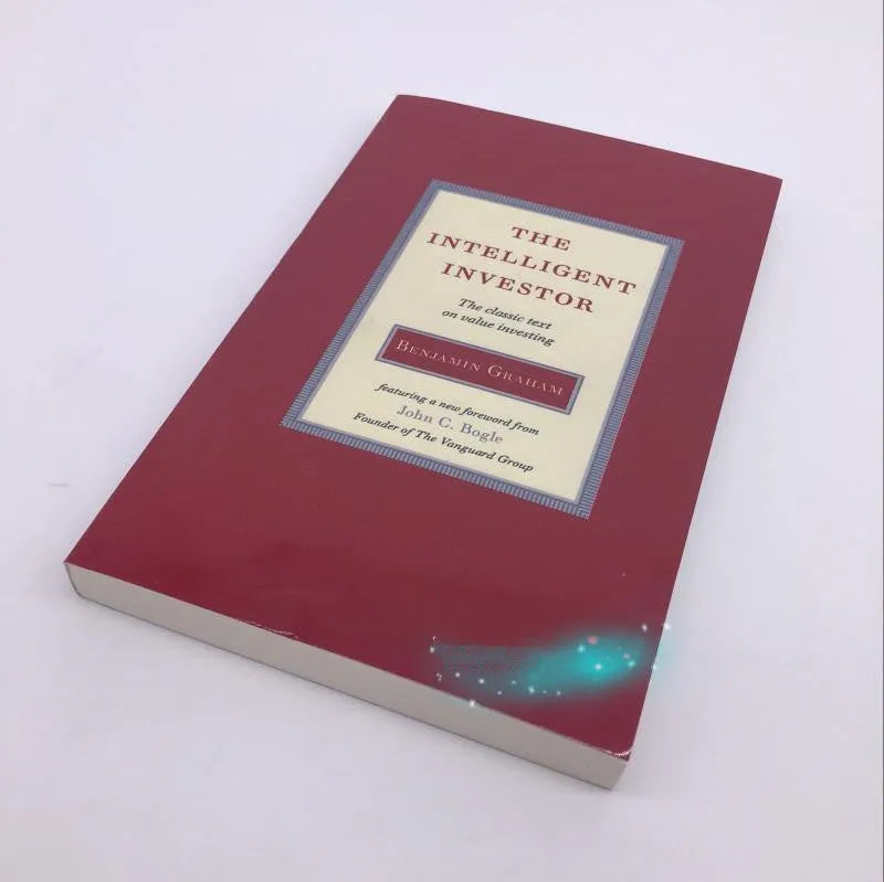 The Intelligent Investor paperback book by Benjamin Graham showing financial investment cover