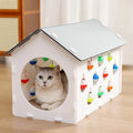 Plastic cat scratch board integrated with nest area and tunnel containing bell balls