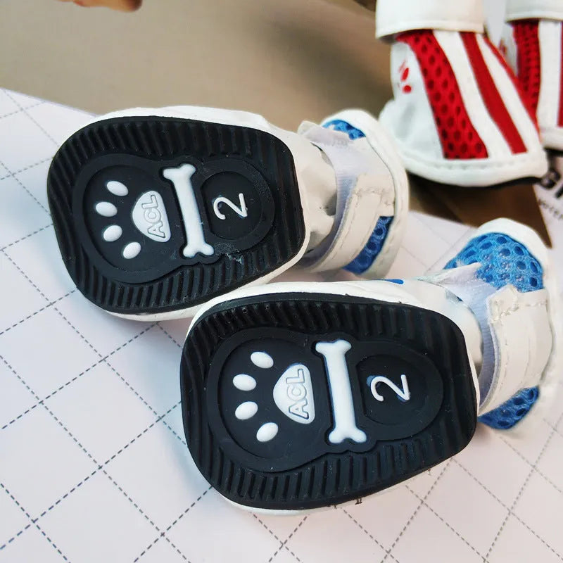 Set of four blue cloth dog shoes with zippers, designed for small breed pets on a white background.