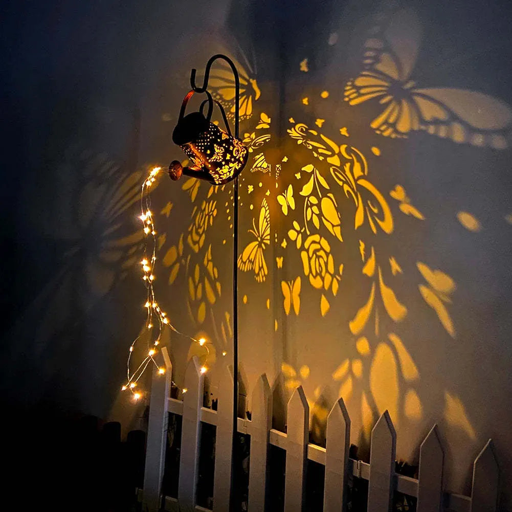 Solar-powered tapered butterfly pattern iron garden lamp emitting warm white light.