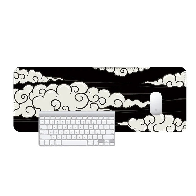 Large Japanese-style cloud pattern desk mat with non-slip rubber base on a wooden desk.