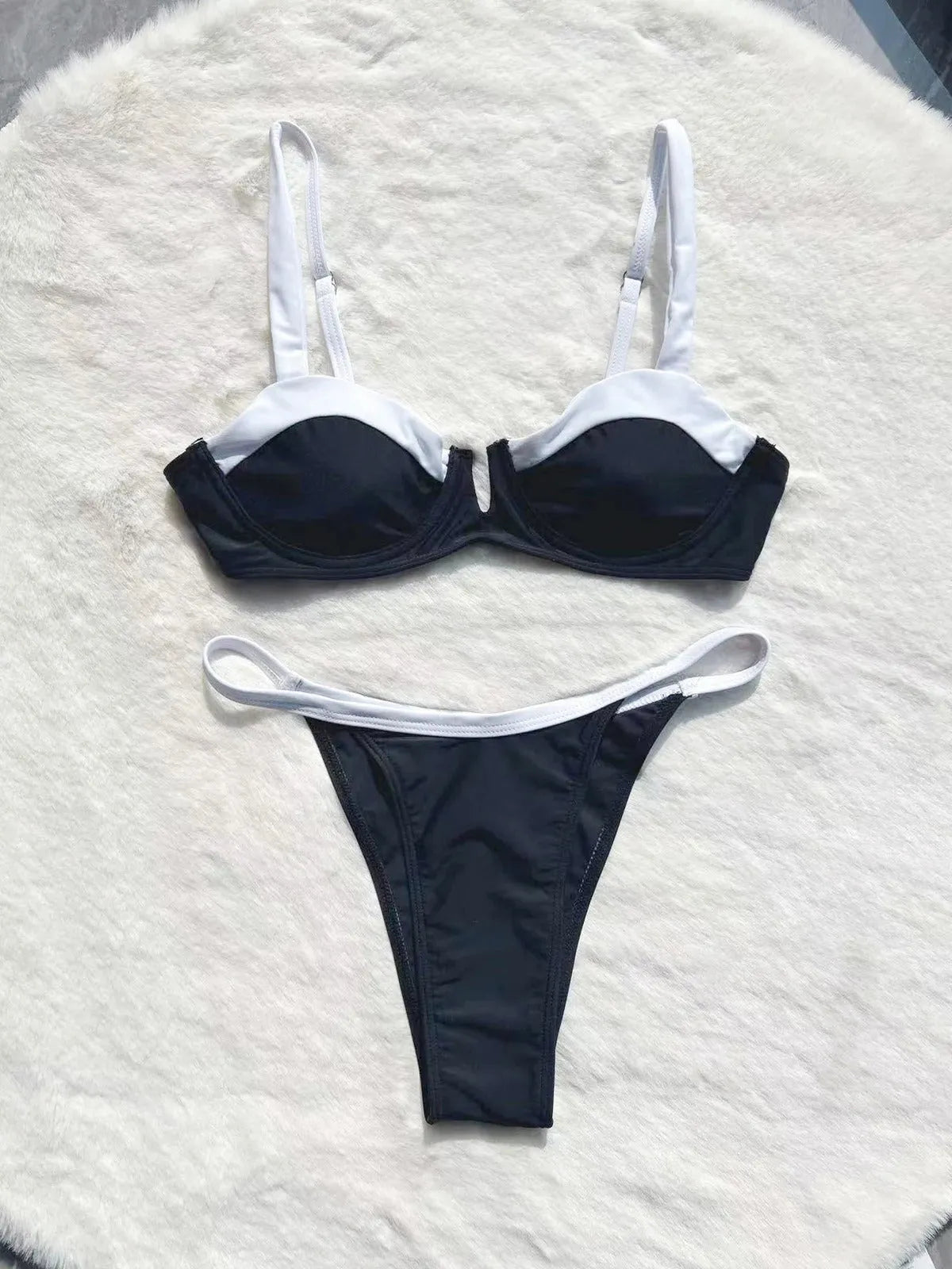 Women's low waist black bikini swimsuit with stitching split detail.