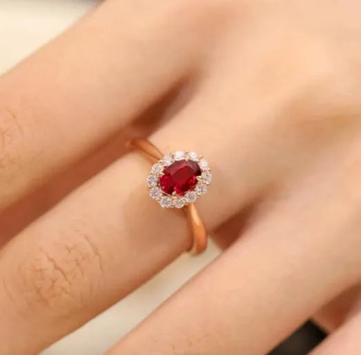 Women's silver-plated floral ring with a gold pigeon red blood gemstone centrepiece.