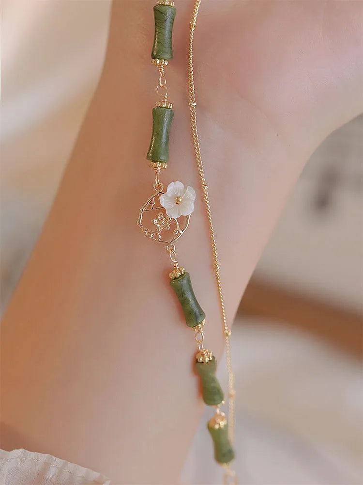 Natural green olivine stone bracelet with double layer Twin Bells of Ireland and Olive Branch design on an adjustable band.