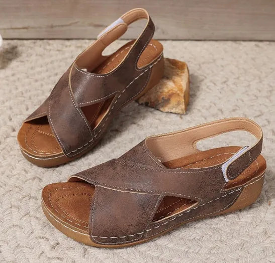Women's brown Roman platform sandals with an open toe and Velcro strap closure on a rubber sole.