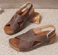 Women's brown Roman platform sandals with an open toe and Velcro strap closure on a rubber sole.