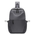 Men's grey waterproof large chest bag with shoulder strap, showing front pocket and main compartment.