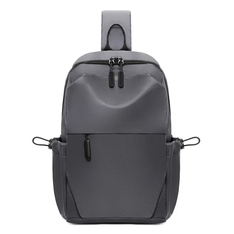 Men's grey waterproof large chest bag with shoulder strap, showing front pocket and main compartment.