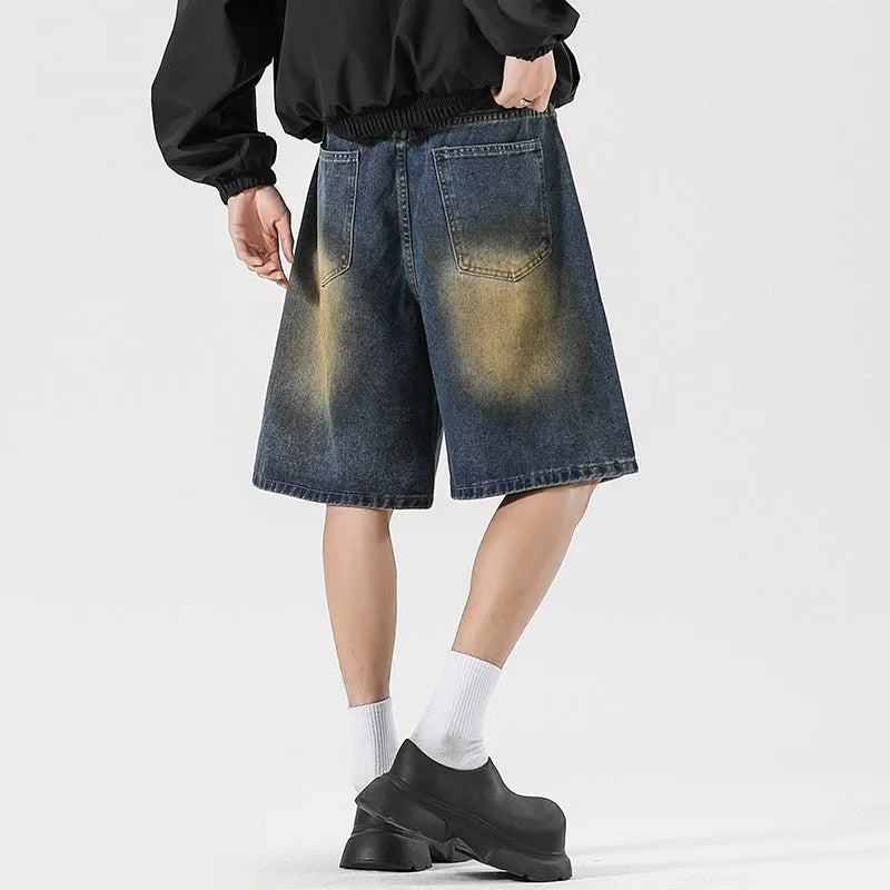 Man's retro blue loose fit jeans with ripped detailing on knees and thighs.