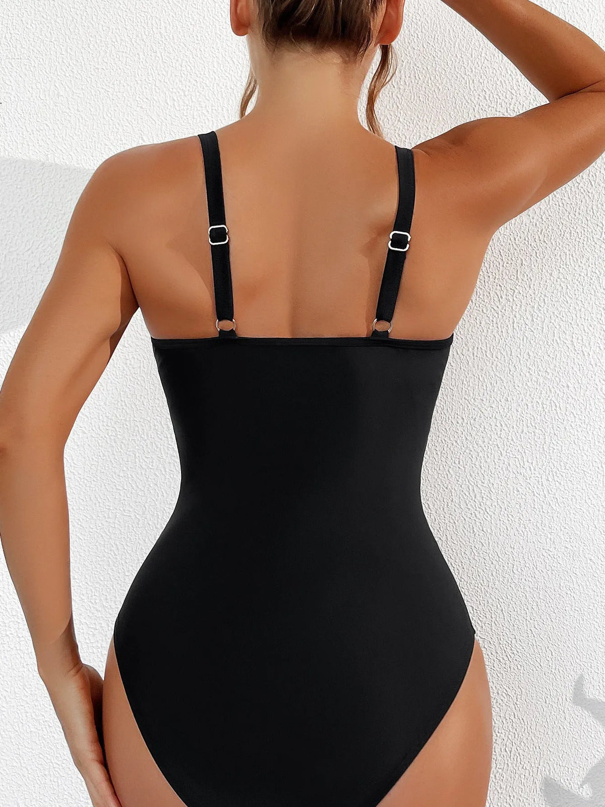 Black women's one-piece halter swimsuit with mesh detailing and briefs styling