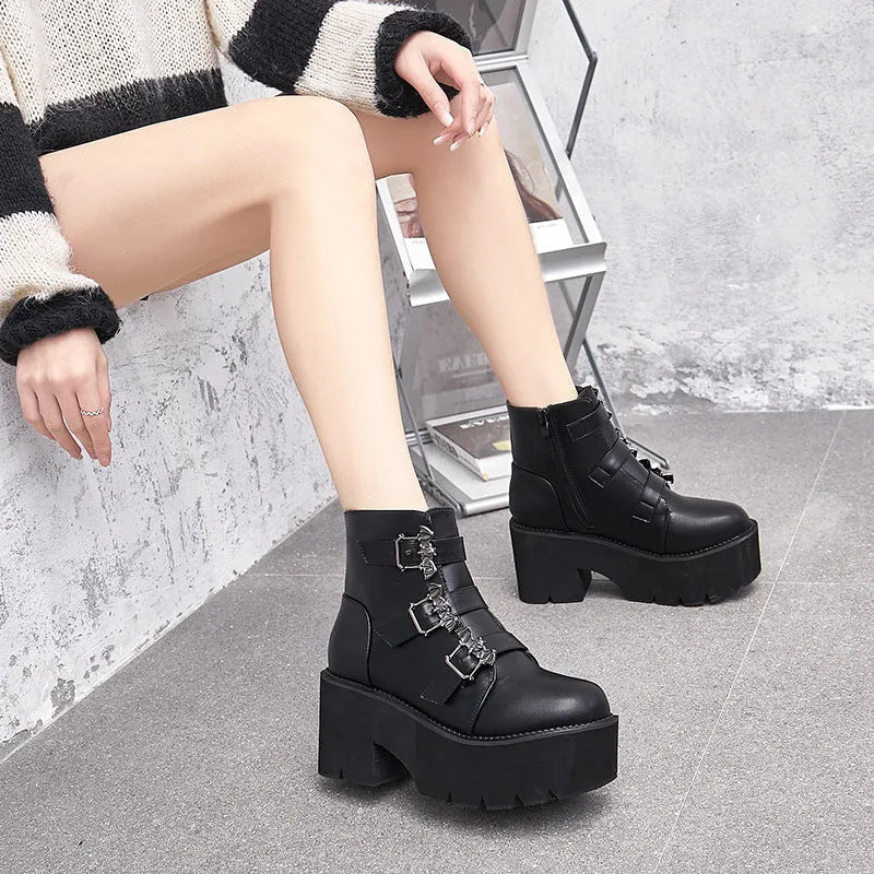 Black women's gothic punk Martin boots with a silver bat buckle and side zip.