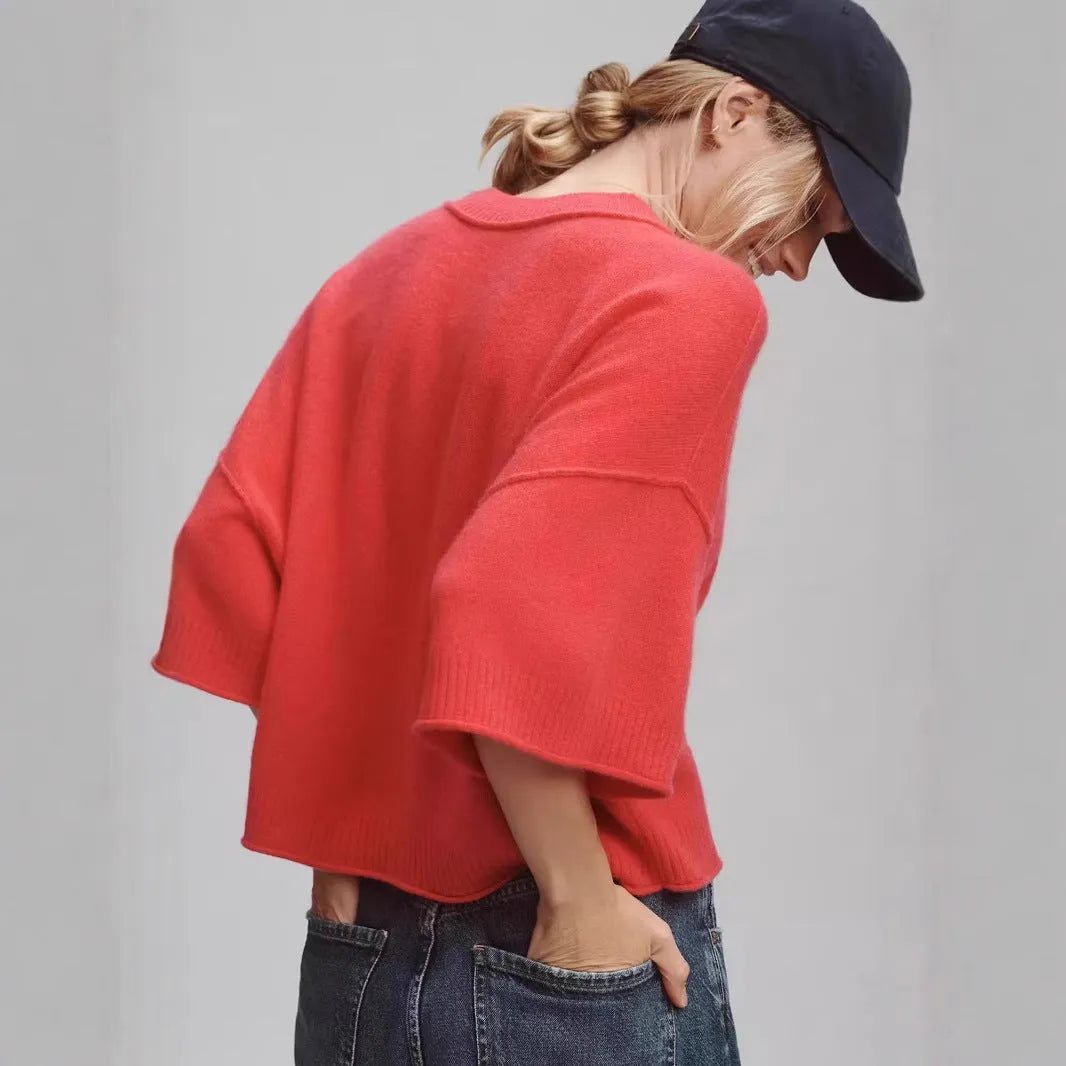 Red cropped viscose t-shirt on a hanger, showing its short length and regular sleeves.