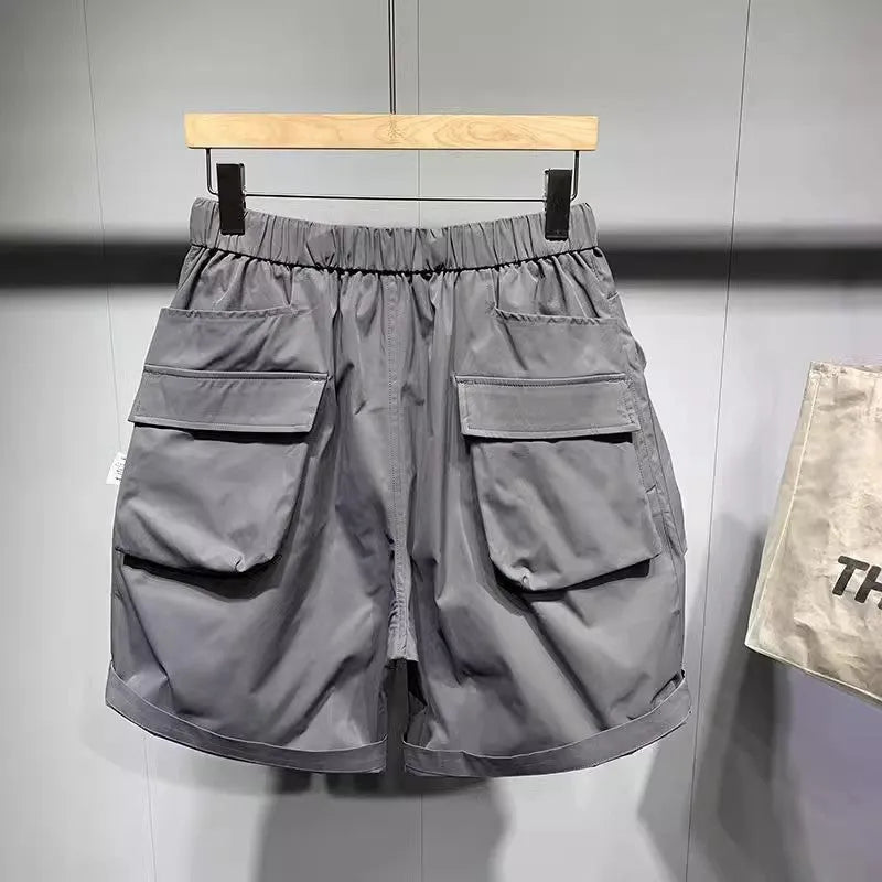 Men's large size work shorts with pockets in black or grey colours showing above knee length and loose fit design