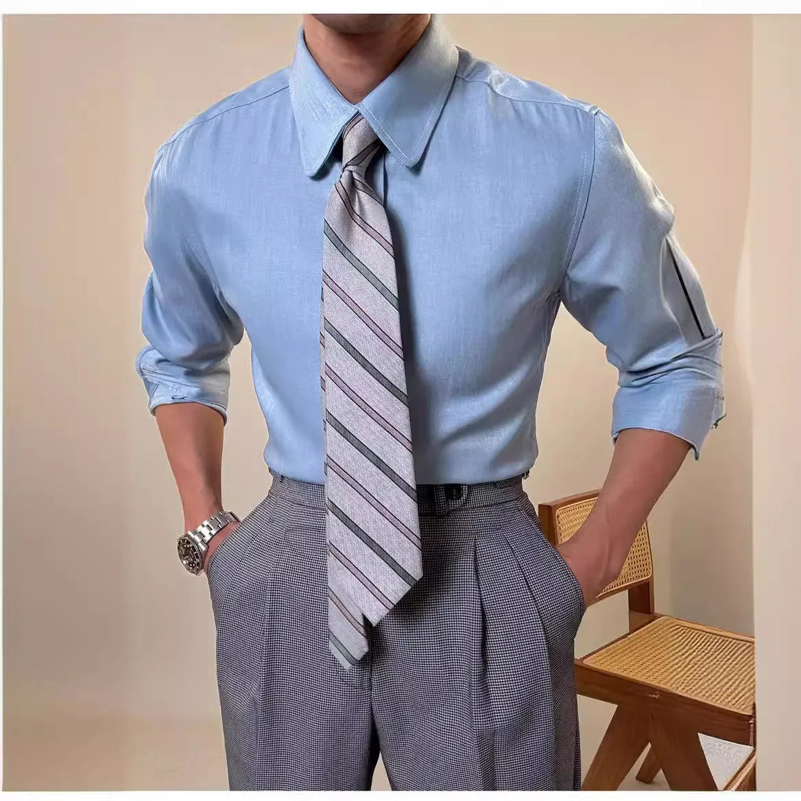 Man wearing a slim fit light blue long sleeve shirt with a round collar