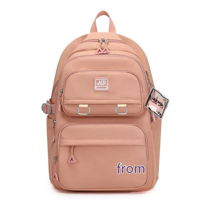 Girls large purple nylon school backpack with anti-theft features and ergonomic back support.