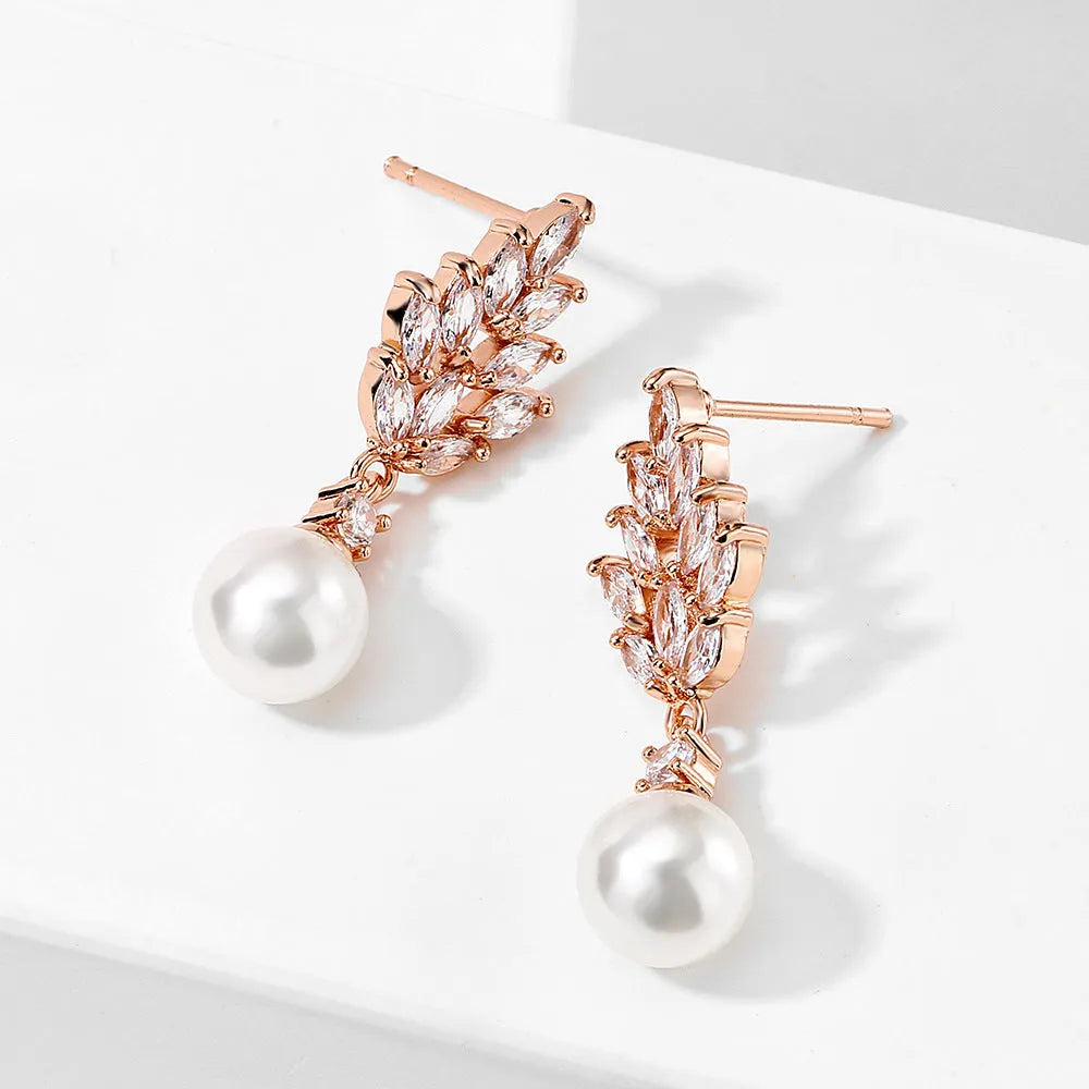 Pearl earrings with micro zircon accents in geometric flower design available in three metal plating options