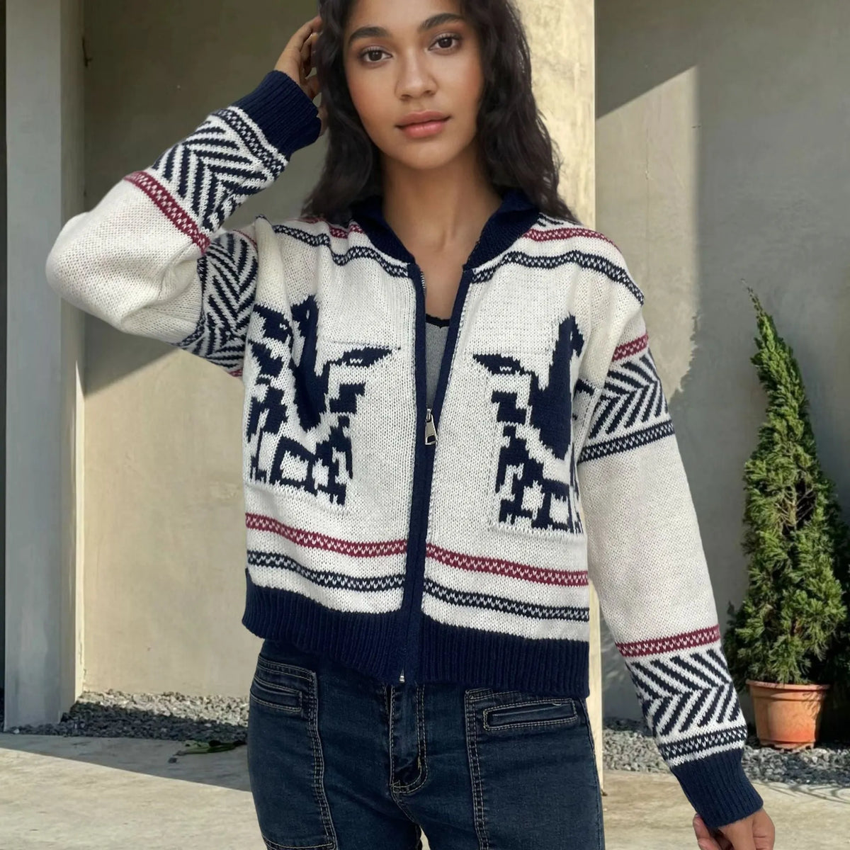 White women's cardigan with jacquard stripe pattern, zip front, and lapel collar on a hanger.