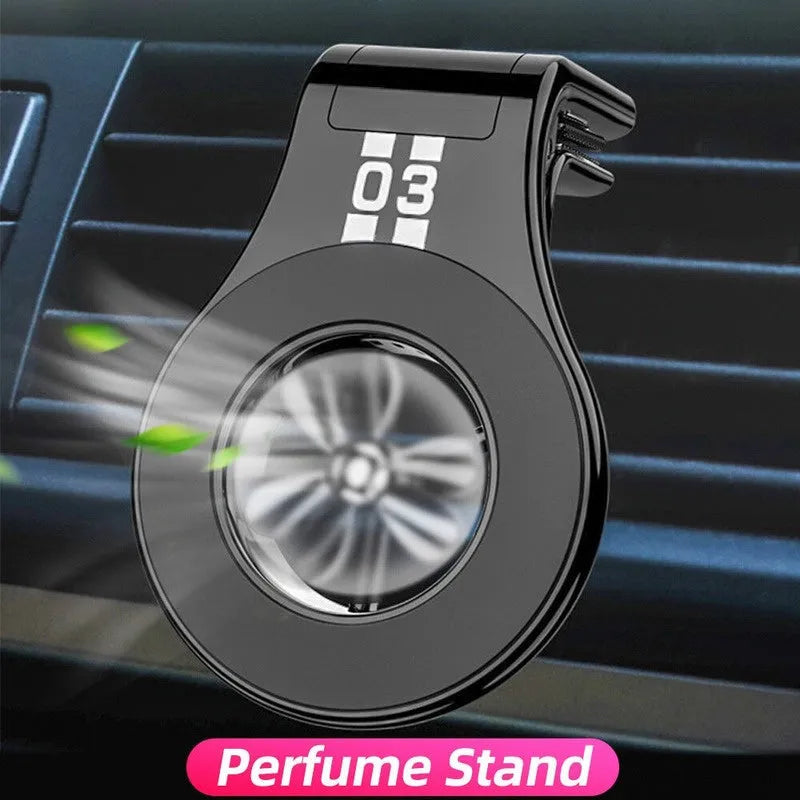 Black magnetic car phone holder with fragrance slice mounted on a car air vent