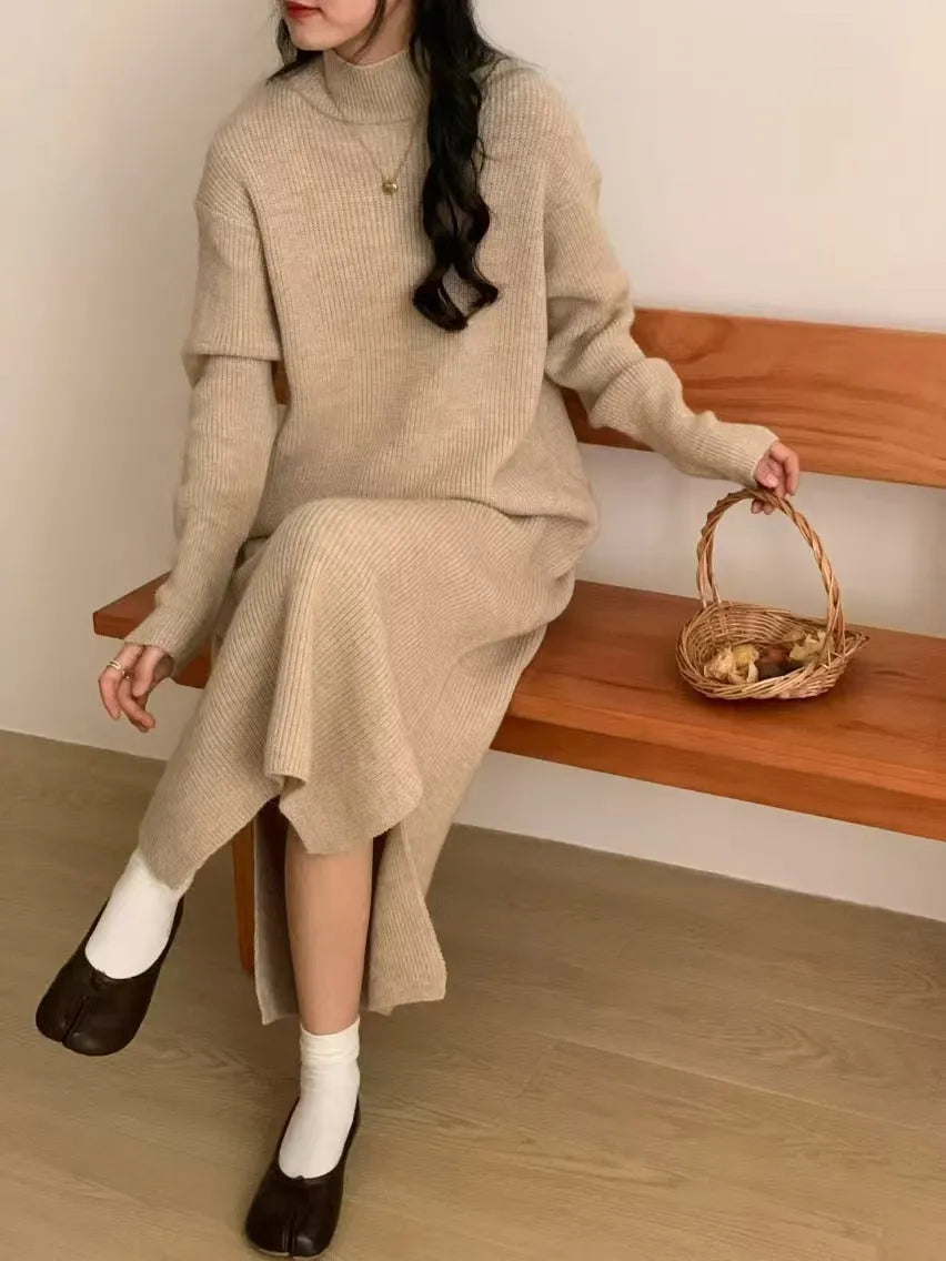 Solid colour knitted dress with half turtleneck collar and long sleeves, shown in a neutral colour.